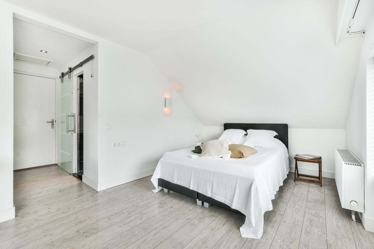 Bright, tidy bedroom with a neatly made bed in a well-kept home