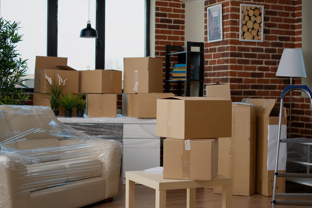 Living room of a new home with moving boxes stacked and ready to unpack