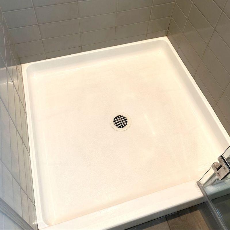 Shower pan cleaned and brightened (after)