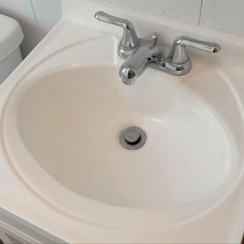 Grime removed from a bathroom vanity sink (after)