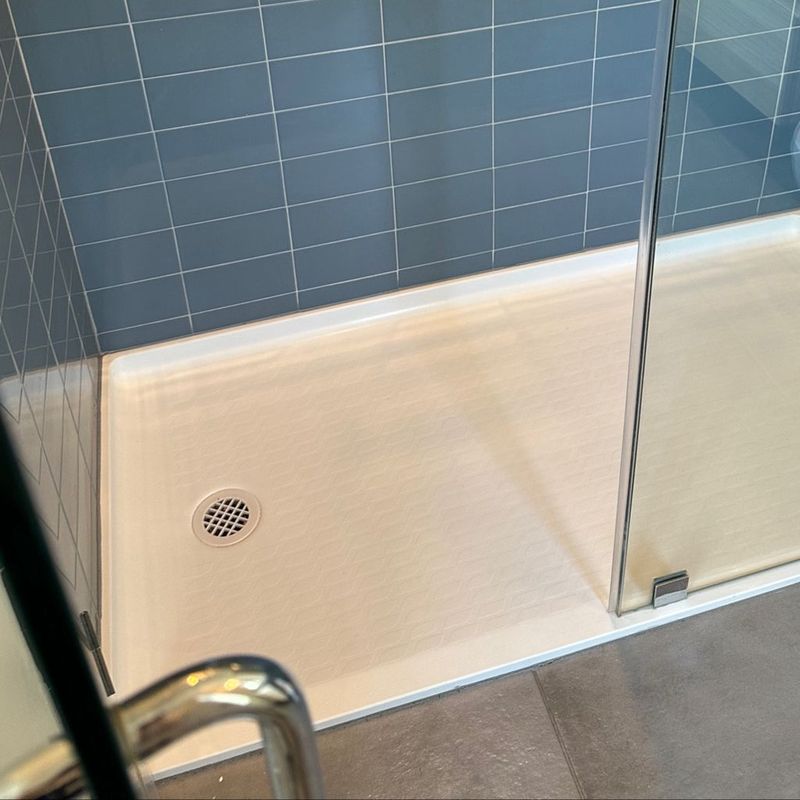 Shower base and glass cleaned in detail (after)